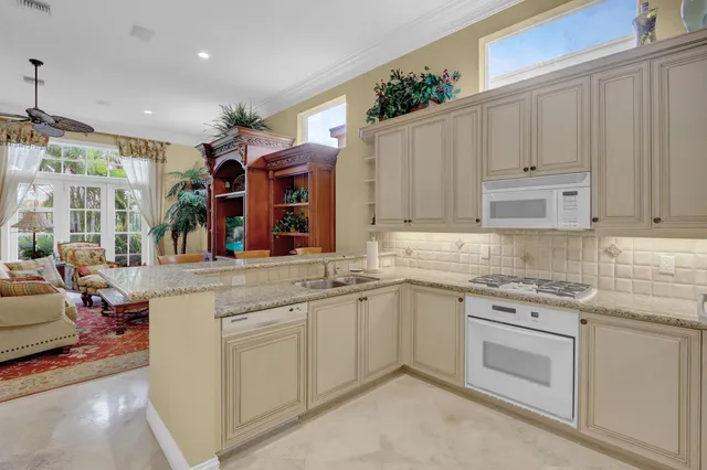 a kitchen with white cabinets and white appliances