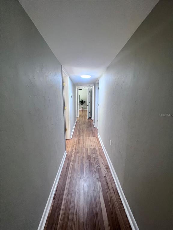 3857 West University Avenue Gainesville, FL 32607 - Photo 12 of 17 a view of a hallway with wooden floor