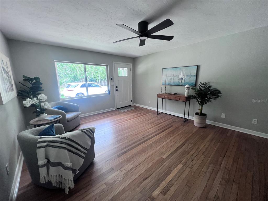 3857 West University Avenue Gainesville, FL 32607 - Photo 13 of 17 a living room with furniture and a wooden floor