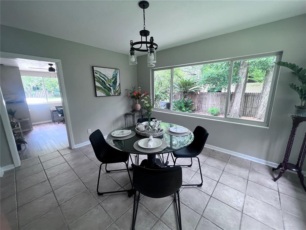 3857 West University Avenue Gainesville, FL 32607 - Photo 16 of 17 a view of a dining room with furniture and a chandelier
