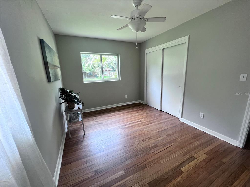 3857 West University Avenue Gainesville, FL 32607 - Photo 4 of 17 an empty room with wooden floor and windows