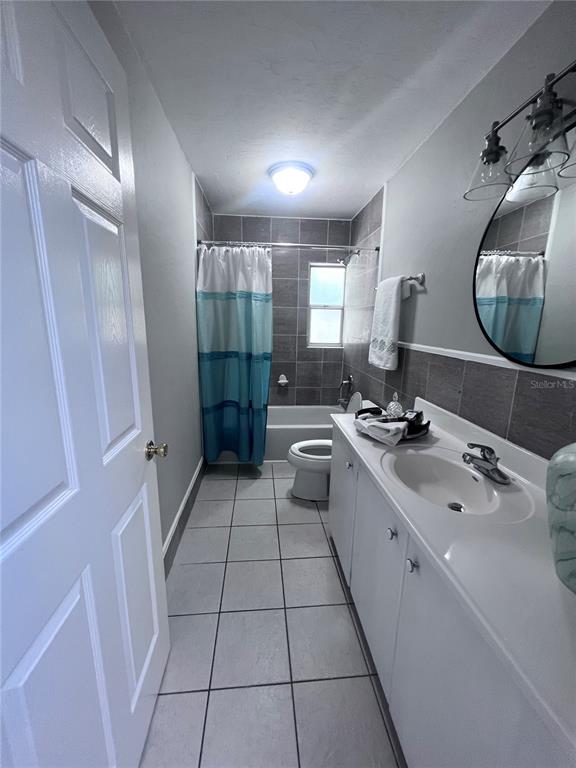 3857 West University Avenue Gainesville, FL 32607 - Photo 10 of 17 a large white bathroom with a double vanity sink a mirror and a shower