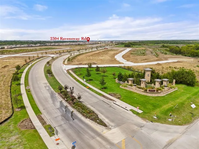 a view of a swimming pool with a garden and seating area