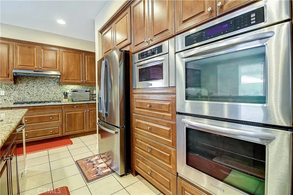 a kitchen with a table chairs sink and cabinets