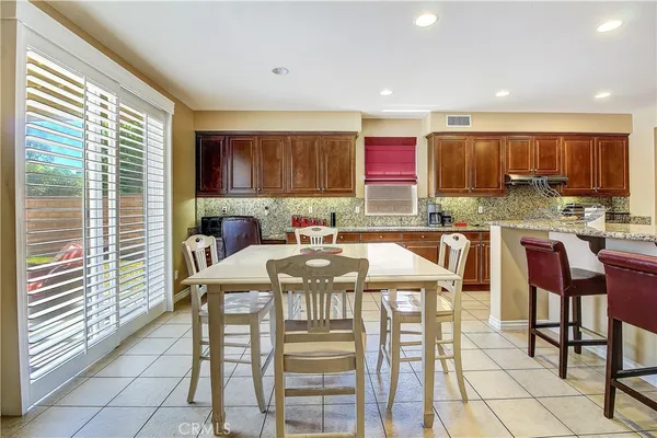a living room with furniture a rug and kitchen view