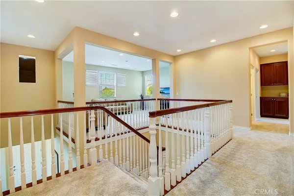 a view of a hallway with a livingroom and a hall with wooden floor