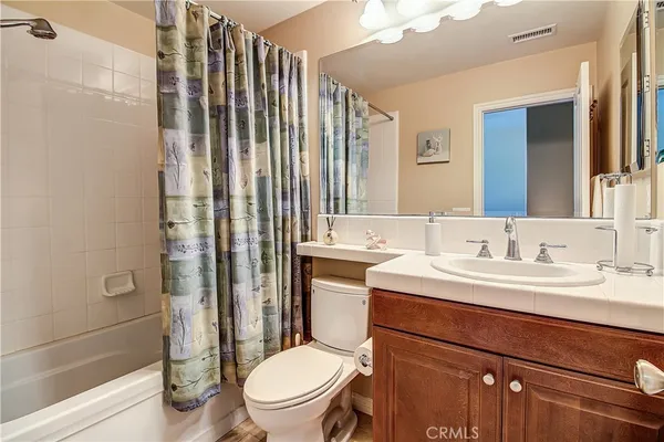 a view of yard with table and chairs under an umbrella