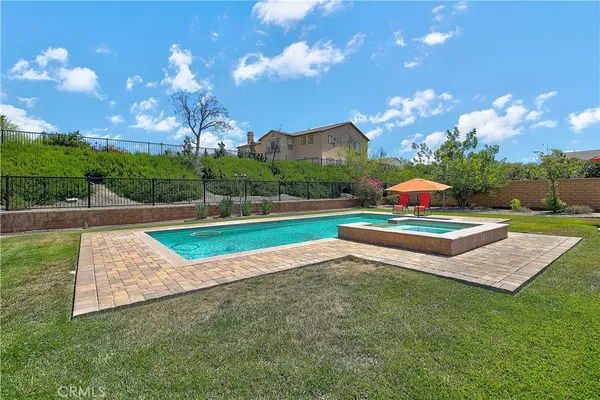 a view of a tennis ground with large trees