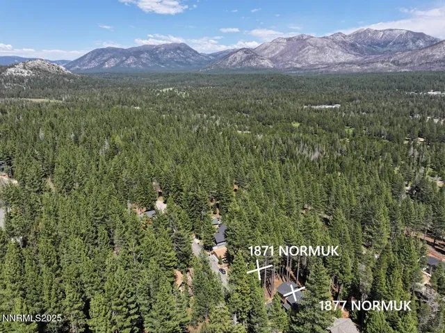a view of a houses with a lush green hillside