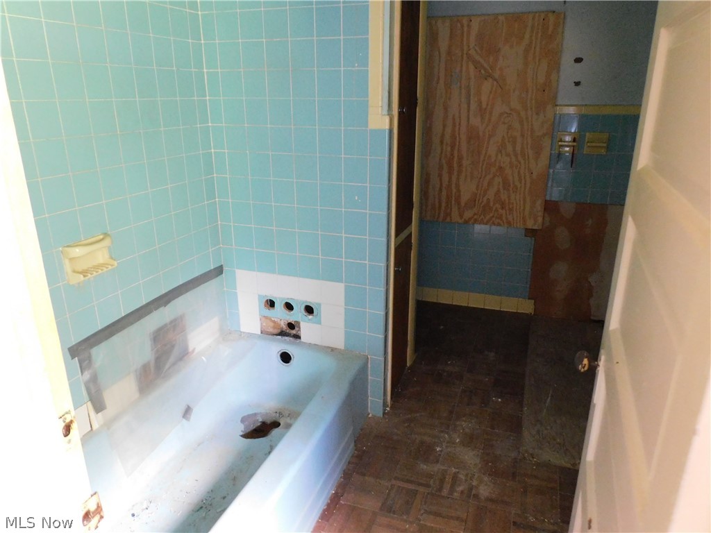 4031 South Ridge Road East Ashtabula, OH 44004 - Photo 12 of 25 Bathroom featuring tile patterned flooring and tile walls