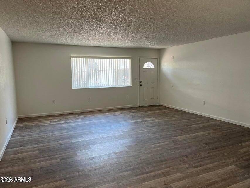 860 East Brown Road, Unit 53 Mesa, AZ 85203 - Photo 3 of 14 wooden floor in an empty room with a window