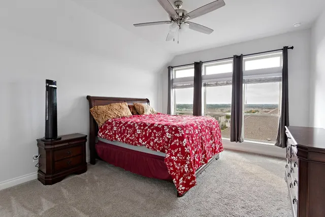 a bedroom with a bed table and window