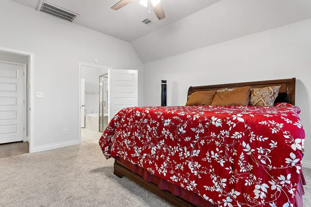 a bed room with a bed and a chair