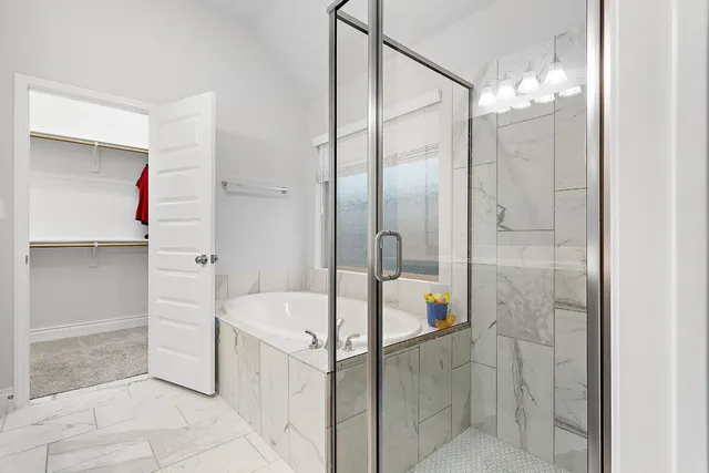 a bathroom with a tub shower and sink
