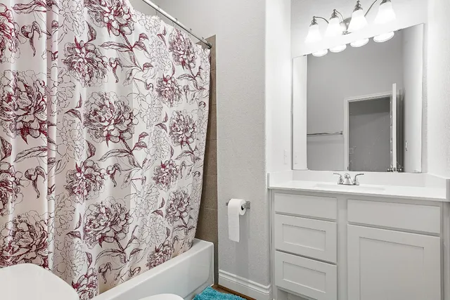 a bathroom with a sink and a mirror with bathtub