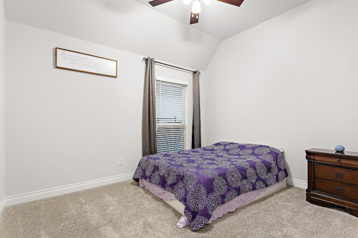 321 Berkeley Place Georgetown, TX 78628 - Photo 19 of 23 a bedroom with a bed and a ceiling fan