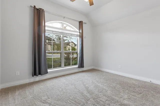 an empty room with windows and city view