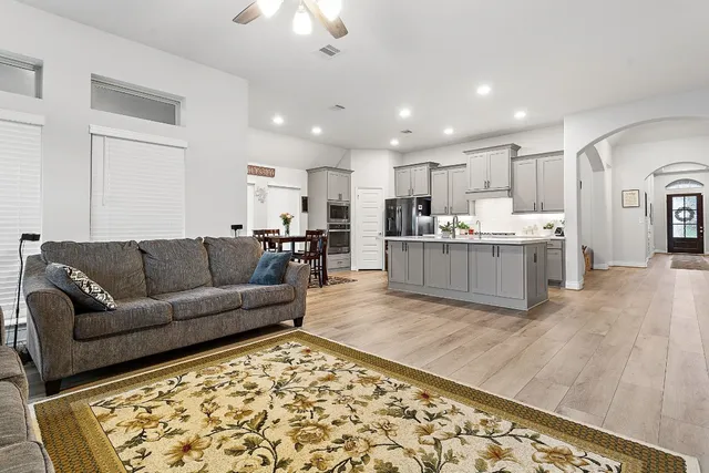 a living room with furniture and kitchen view