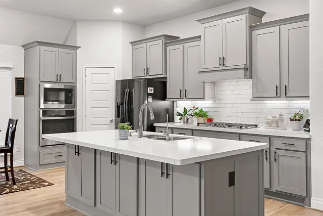 a kitchen with stainless steel appliances a sink stove and refrigerator