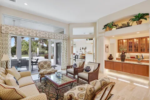 a large kitchen with granite countertop a large counter top appliances and cabinets