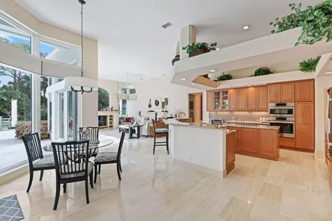 a kitchen with granite countertop stainless steel appliances a sink and cabinets