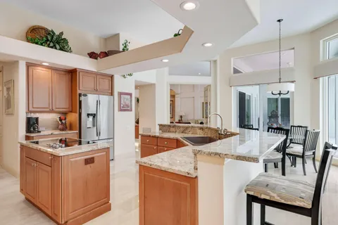 a living room with furniture a fireplace and a floor to ceiling window