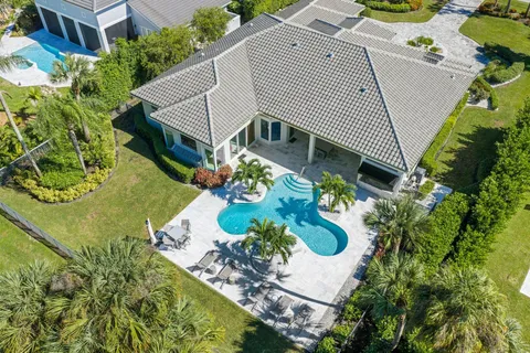 a aerial view of a house with a yard and potted plants