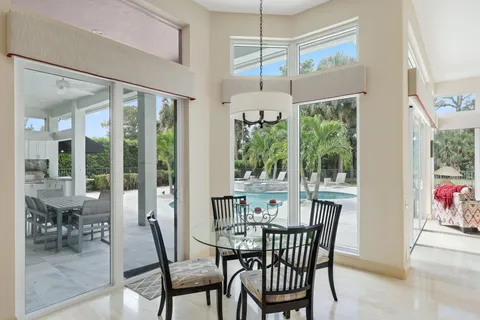 a large white bathroom with a large tub sink and window