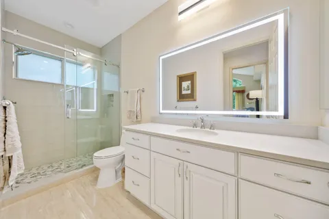 a backyard of a house with fountain table and chairs