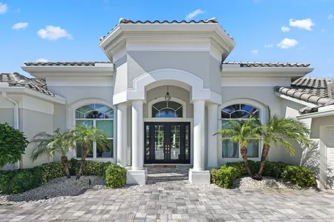 a large white kitchen with a large window