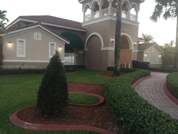 a front view of a house with garden
