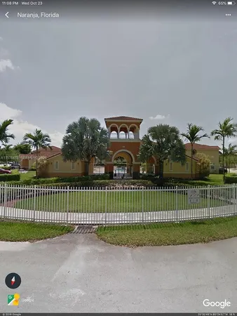 a view of a fence and a bench in a park