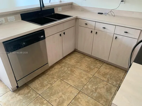 a kitchen with a sink and cabinets