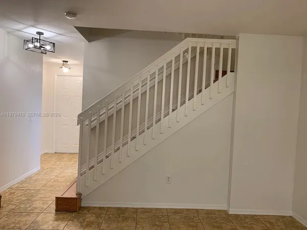 a kitchen with granite countertop cabinets and refrigerator