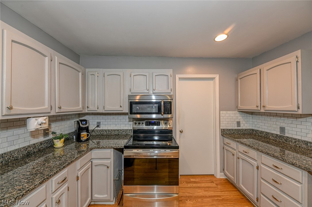 1275 Sandy Lake Road Ravenna, OH 44266 - Photo 11 of 34 Kitchen work space, stove and microwave.
