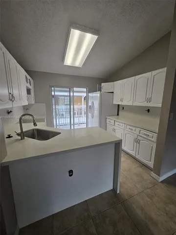 a kitchen with stainless steel appliances a sink stove and cabinets