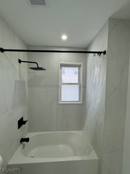 96 Broughton Avenue Bloomfield, NJ 07003 - Photo 12 of 14 a bathroom with a bathtub and a shower