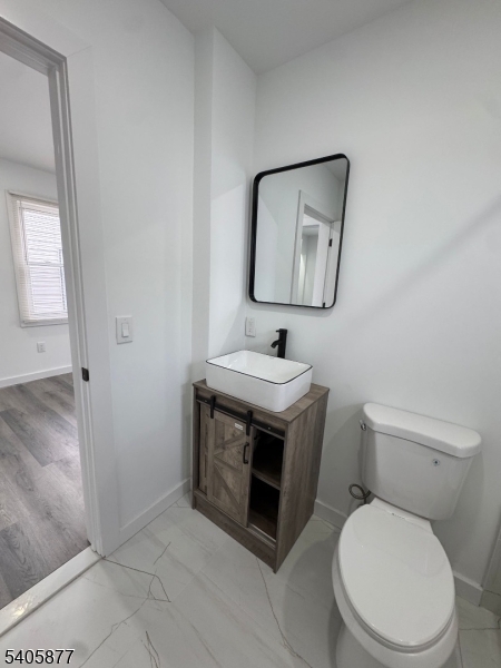 96 Broughton Avenue Bloomfield, NJ 07003 - Photo 13 of 14 a bathroom with a toilet sink and mirror