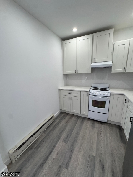 96 Broughton Avenue Bloomfield, NJ 07003 - Photo 2 of 14 a kitchen with a sink a stove and cabinets