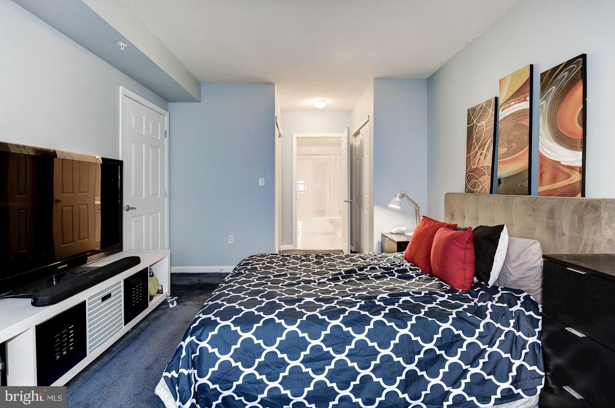 2726 Gallows Road, Unit 1315 Vienna, VA 22180 - Photo 15 of 30 a bedroom with a bed and a flat screen tv