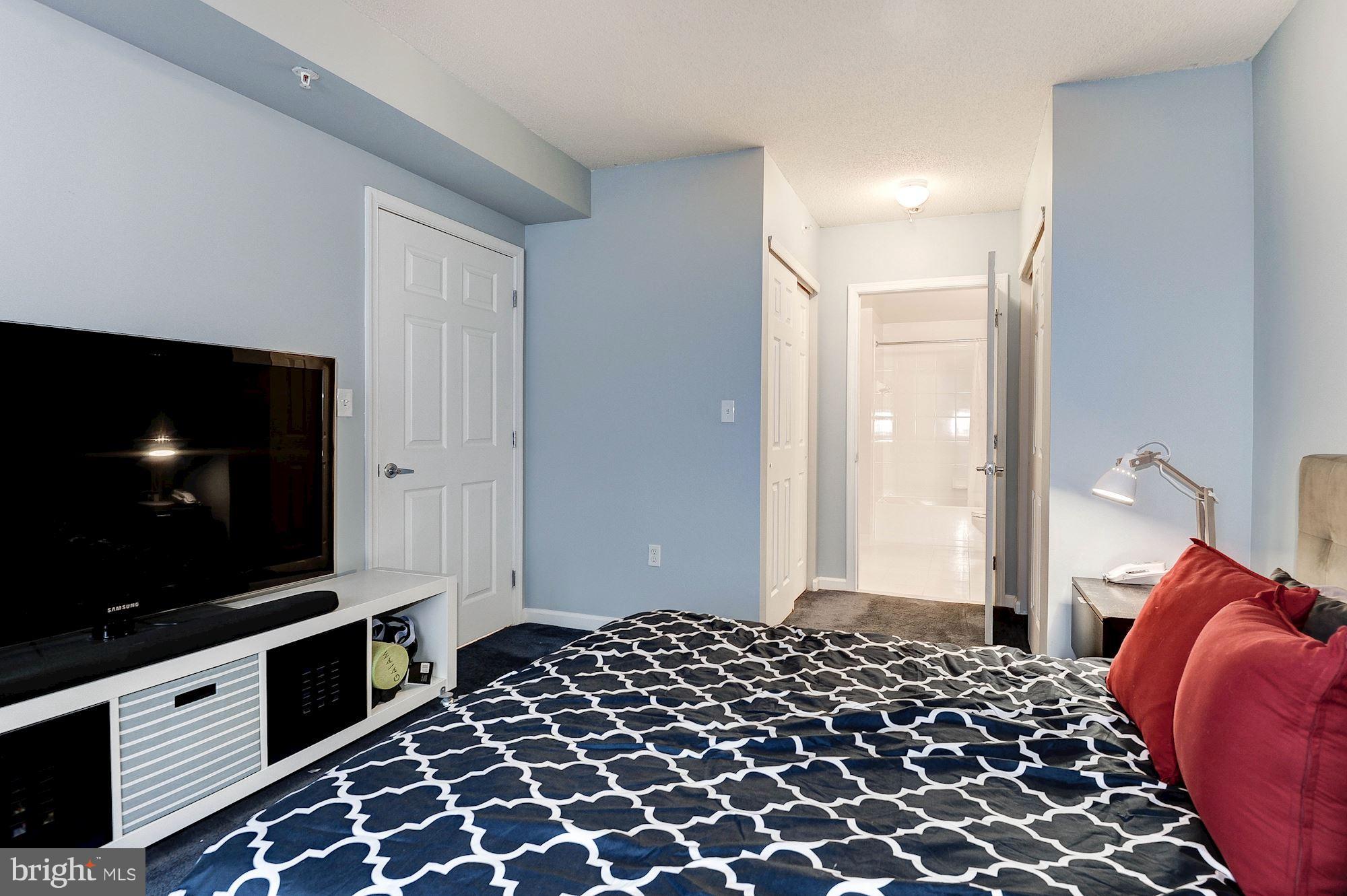 2726 Gallows Road, Unit 1315 Vienna, VA 22180 - Photo 16 of 30 a bedroom with bed and flat screen tv