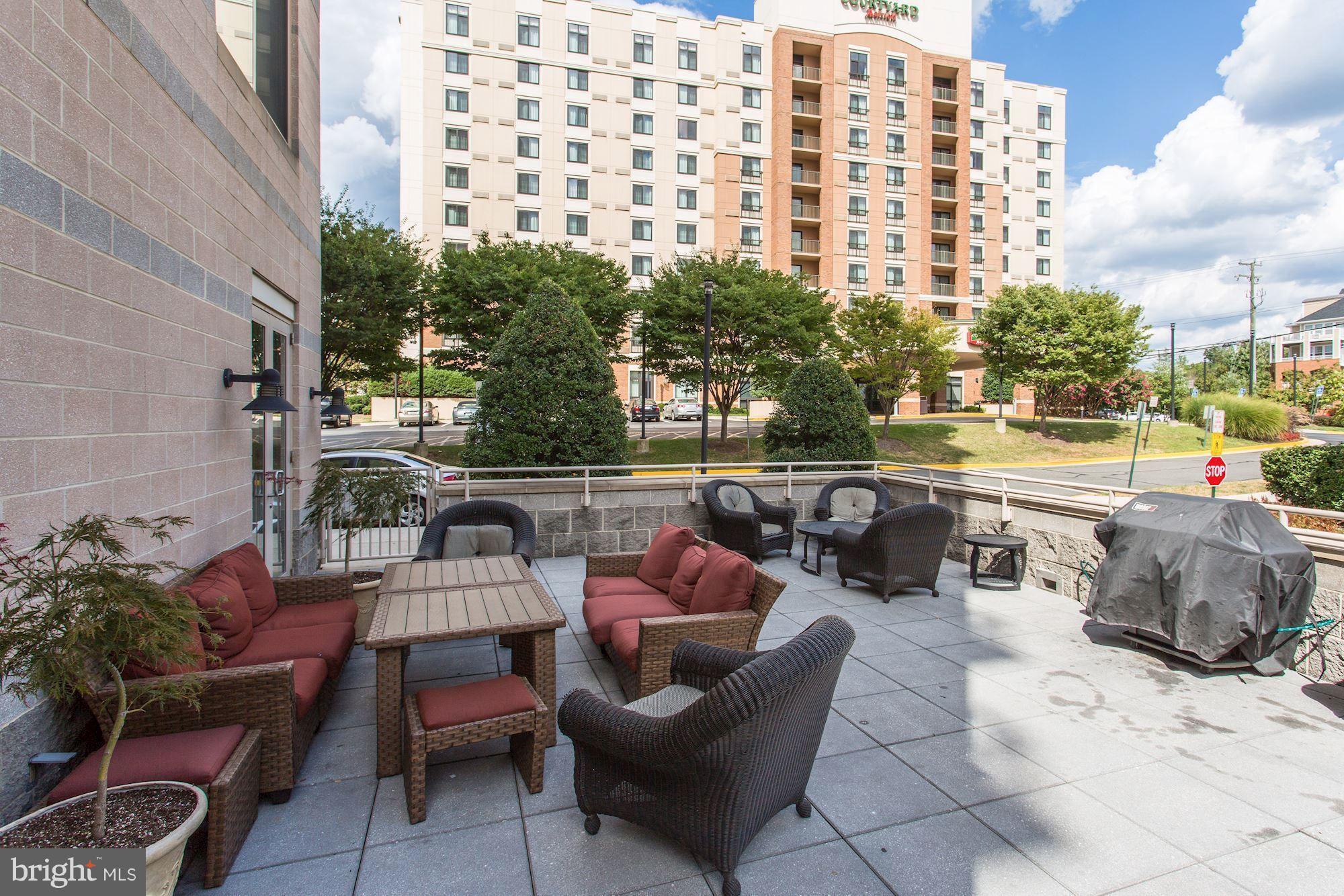 2726 Gallows Road, Unit 1315 Vienna, VA 22180 - Photo 3 of 30 a view of a roof deck with couches and potted plants