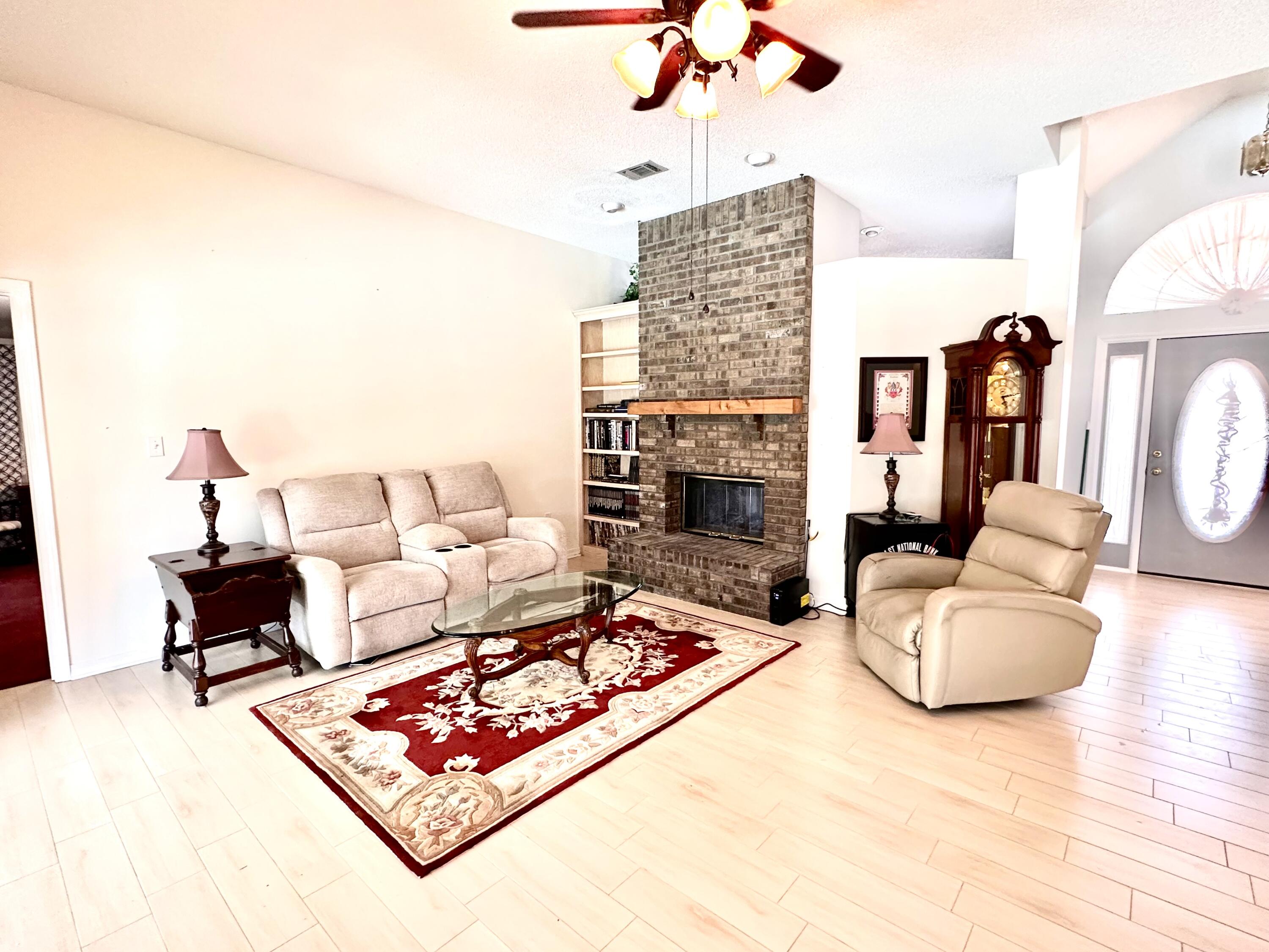 2405 Valley Road Navarre, FL 32566 - Photo 19 of 32 a living room with furniture and a fireplace