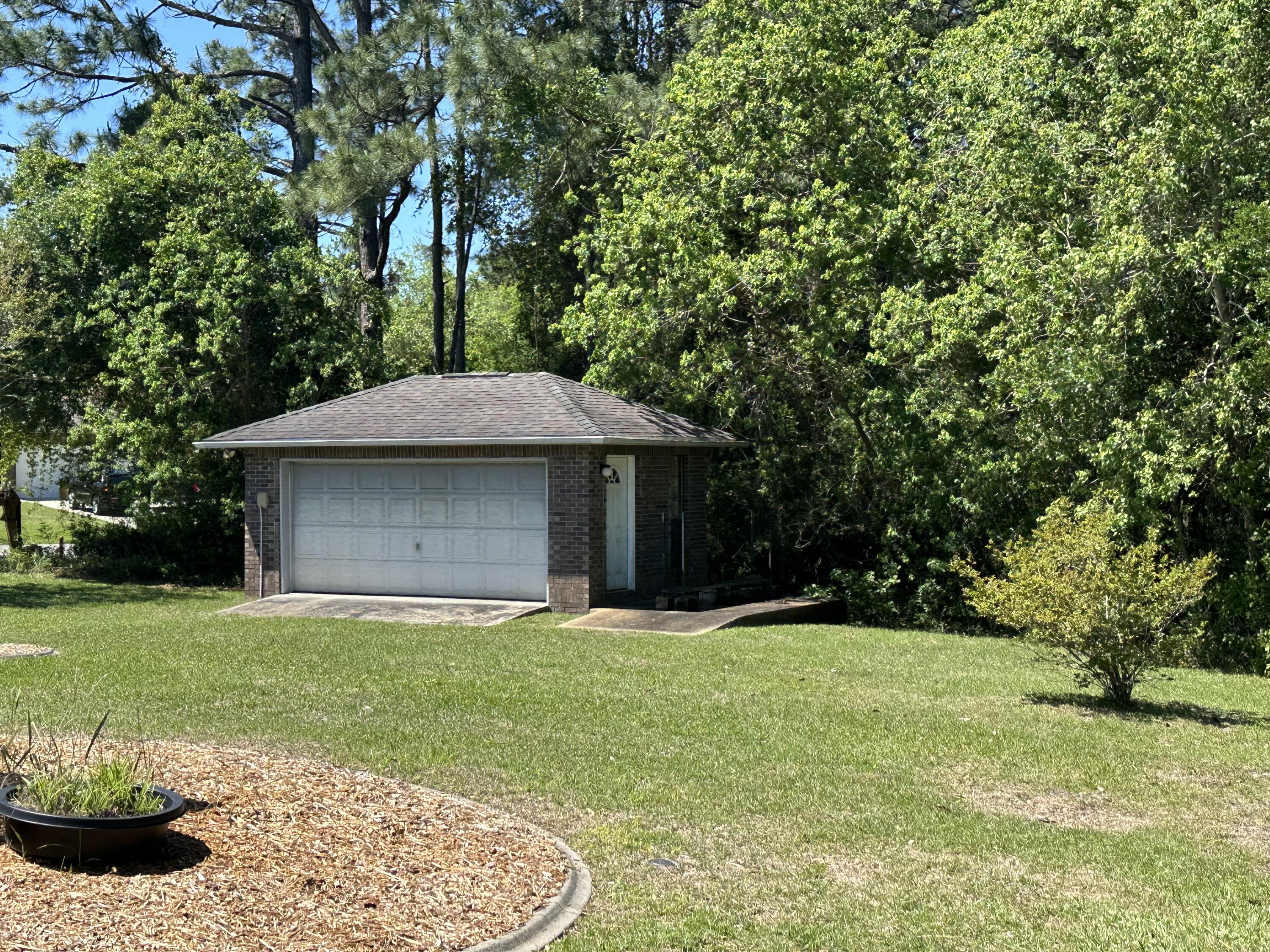 2405 Valley Road Navarre, FL 32566 - Photo 8 of 32 a front view of a house with a yard