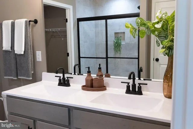 a bathroom with a double vanity sink and a mirror