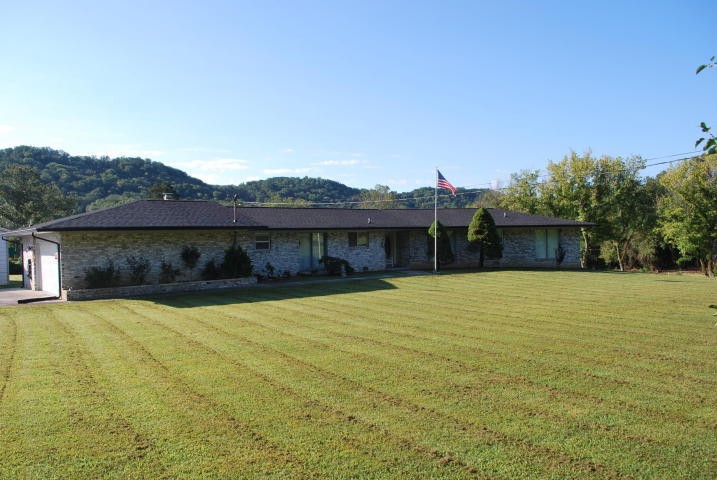 2736 East Raccoon Valley Drive Heiskell, TN 37754 - Photo 1 of 37 a view of a house with a yard and a large tree