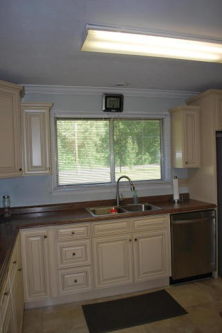 2736 East Raccoon Valley Drive Heiskell, TN 37754 - Photo 22 of 37 a kitchen with white cabinets and a window