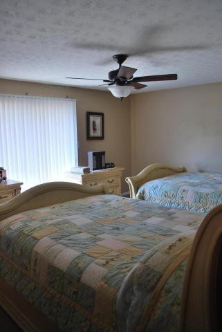 2736 East Raccoon Valley Drive Heiskell, TN 37754 - Photo 35 of 37 a bedroom with a bed and a chandelier