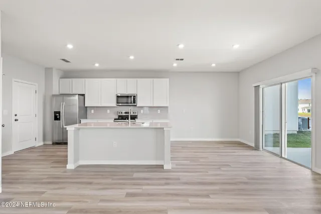 a view of kitchen with wooden floor