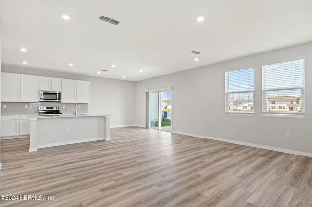 a view of kitchen with granite countertop cabinets and wooden floor